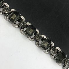 Vintage 1960's Bracelet, Retro Gray Jewelry, Gray Rhinestone Chunky Wide Bracelet, Old Hollywood Glam, Mid-Century Jewelry, Collectible Jewelry In very good vintage condition...  Measures: 7 inches long by 1 inch wide. Marked: none Dates: 1950's 1960's Hope you enjoy.... FYI.... I am always listing many items from vintage purses, compacts, vintage jewelry to collectibles Hope you are able to come back often... Stop on by for a lot more .... www.etsy.com/shop/martinimermaid #vintage #gray #chunky Vintage Jubilee Bracelet For Evening, Vintage Adjustable Crystal Bracelet For Party, Vintage Metal Bracelets For Evening, Vintage Silver Jeweled Bracelets, Vintage Metal Bracelets For Evening Wear, Retro Jeweled Bracelets For Formal Occasions, Retro Jeweled Bracelet For Formal Occasions, Vintage Jeweled Bracelets For Party, Antique Jeweled Bracelets For Party