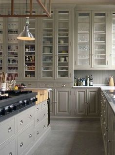 a kitchen filled with lots of counter top space next to a stove top oven and sink