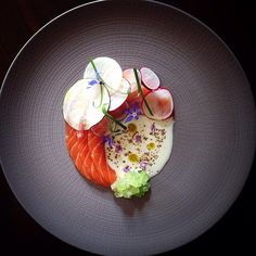 a plate that has some kind of food on it with radishes and other veggies