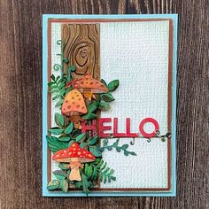 a card made with the word hello on it and mushrooms, leaves, and vines