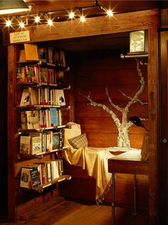 an image of a room with bookshelves and lights on the wall above it