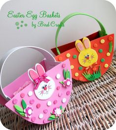 two easter baskets sitting on top of a wicker table