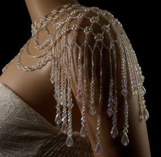 the back of a mannequin with beads and chains on it