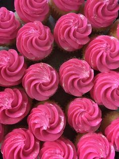 cupcakes with pink frosting are arranged in a circle