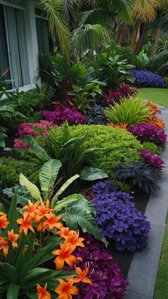 a garden with lots of colorful flowers and greenery