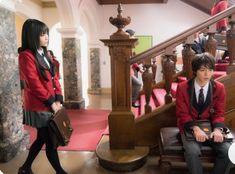 two young people dressed in school uniforms sitting on benches