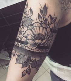 a woman's arm with flowers on it