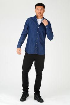 "Looking for a stylish and versatile shirt that you can wear with just about anything? Check out our slim fit denim shirt! Made from 100% cotton, this shirt is comfortable to wear and easy to care for. The blue indigo denim fabric looks great with jeans or khakis, and the slim fit ensures a flattering look. The button front fastening and grandad collar give this shirt a classic look, while the long sleeves make it perfect for cooler days. So whether you're headed to the office or out on the town Style Boyfriend Shirt, Long Denim Shirt, Denim Shirt Style, Fitted Denim Shirt, Blue Denim Shirt, Hooded Denim Jacket, Denim Shirt Men, Shirts Summer, Indigo Denim