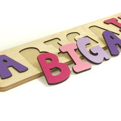 "A gift you love giving, our wooden name puzzles are a wonderful learning toy to give for birthdays, baby showers and \"Just because I Love You\"! * FREE 2 Day Shipping! * Thoughtful personalized gift * Fun and educational * Perfectly match personality and room decor * Display Stand available separately (see link below) * Handmade in Upstate, NY! COLORS: Bright Pink, Purple, Lavender, and Pink Puzzles are a fun learning toy that encourage name recognition, spelling, and fine motor skills. They a Pink And Purple Nursery, Purple Nursery, Best Educational Toys, Girls Personalized Gifts, Jigsaw Puzzles For Kids, Personalized Puzzles, Puzzles For Toddlers, Diy Toddler, Name Puzzle