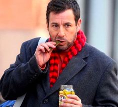 a man wearing a red scarf eating food