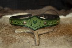 a close up of a leather headband on a fur surface with glasses in the background