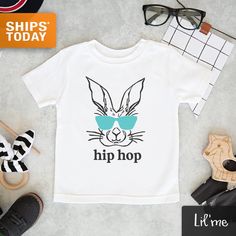 "Our Award-Winning LilMe© threads are 100% designed, printed, pressed and shipped (next business day!) to you from our Upstate New York boutique. ** Quick Sizing Tip ** Onesies are printed on Gerber organic. These tend to run small so we recommend sizing up if you are on the fence. Toddler shirts are true to size. 📋 HOW TO ORDER: ✧ Choose onesie® or shirt size (sizing chart below) and sleeve length ✧ Select design color if applicable ✧ For personalized designs - enter customization in \"Add you Unisex Printed White Tops, Unisex White Printed Tops, Playful Custom Print Tops For Spring, Unisex Cute Shirt For Spring, Cute Unisex Shirt For Spring, Fitted Screen Print Shirt For Spring, Playful Pre-shrunk Shirt For Spring, White Custom Print Shirt For Spring, White Shirt With Custom Print For Spring