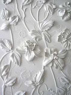 an intricately designed wall with flowers and leaves