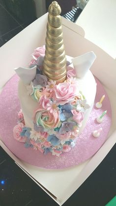 there is a cake in the shape of a unicorn's head with flowers on it