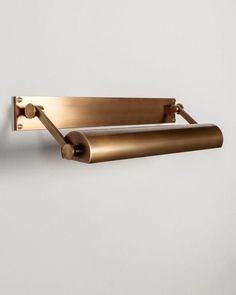 an image of two brass towel racks on the wall