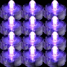 purple lights are arranged in rows on a black background