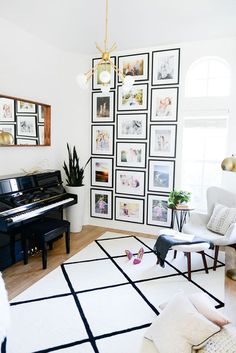 a living room with a piano and pictures on the wall