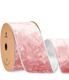 a roll of pink velvet ribbon on white background