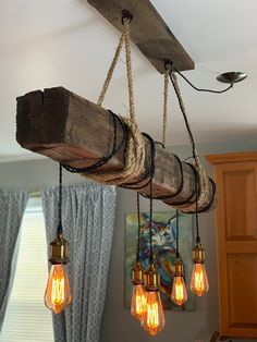 some light bulbs hanging from a wooden beam