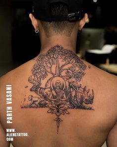 the back of a man's neck with tattoos on it