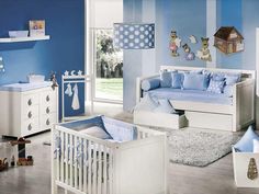 a baby's room with blue walls and furniture