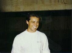 a man standing in front of a building smiling