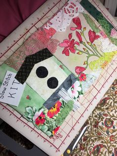 a quilter's cutting board with scissors on it and some fabric in the background