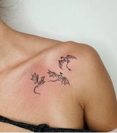 a woman with a tattoo on her shoulder and leaves coming out of the back of her chest