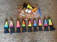 there are many different colored cones on the floor next to scissors and other crafting supplies