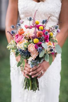 a woman holding a bouquet of flowers in her hands