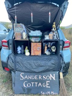 the back end of a car with an open trunk full of items and decorations in it