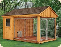 a small wooden dog house in the middle of a yard with a fence around it