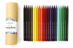 a tube of colored pencils next to a roll of paper