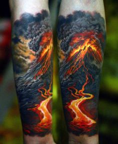 a man's arm with an image of mountains and fire coming out of it