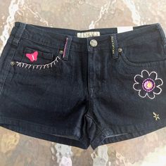 Hand Embroidered Short Shorts For Woman/Junior. Fun Flowers & A Metallic Butterfly Adorn These New Never Worn Shorts. Embroidery Thread Colors Are Pink, Magenta, & Yellow For A Springtime Look. Right Rear Pocket Flower Has Button Center Detail. Hybrid & Co. Brand Jeans. 5 Pocket, Zipper Fly With Metal Button Closure. 78% Cotton, 20% Polyester, 2% Spandex - These Shorts Are Soft Denim With A Nice Comfortable Stretch. 18" Across The Widest Hip Area, 11.5" From Waist To Hem. Hand Wash, Lay Flat Shorts Embroidery, Clothing Refashion, 2000 Clothes, Metallic Butterfly, Jean Pocket Designs, Embroidered Denim Shorts, Booties Outfit, Boho Denim, Boho Festival Fashion