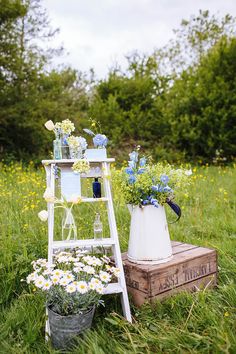 an old ladder is used as a flower stand