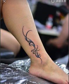 a woman's foot with a tattoo design on it, and the word love written in