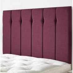 an upholstered headboard with buttons on the top and bottom, made from fabric