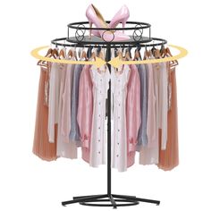 an ironing rack with clothes and shoes hanging on hangers in front of a white background