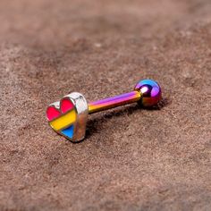 16 Gauge 5/16 Pink Blue Rainbow Pansexual Pride Heart Cartilage Tragus Show off your belief in individual rights when you wear this 16 gauge cartilage jewelry. Made with an 8mm rainbow anodized over 316L surgical grade stainless steel straight barbell, this tragus earring has a 3mm ball end. It features a red, yellow, and blue pansexual pride heart charm so you can show your support anytime. This cartilage stud works beautifully in multiple cartilage piercings, including helix, tragus, and conch Pride Heart, Individual Rights, Cartilage Piercings, Tragus Earring, Cartilage Jewelry, Cartilage Stud, Pansexual Pride, Tragus Earrings, Blue Rainbow