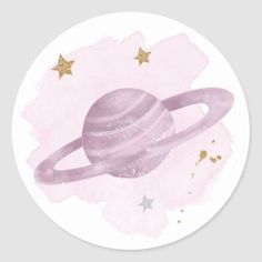 a round sticker with an image of the planet saturn in pink and gold stars