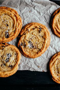 chocolate chip cookies sitting on top of wax paper