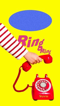 a red telephone sitting on top of a yellow background