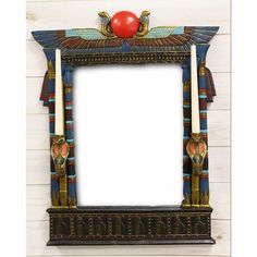 an egyptian style photo frame with red ball in the middle and two columns on each side