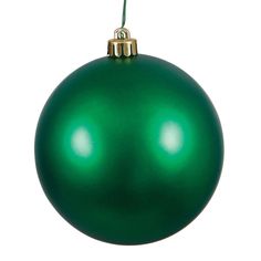 a green christmas ornament hanging from a string