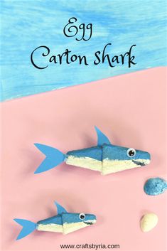 two little sharks made out of paper and some shells on the beach with text overlay that reads 39 carton shark