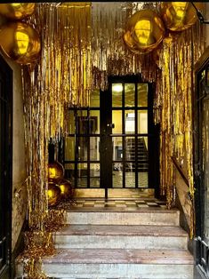 the entrance to a building decorated with gold streamers