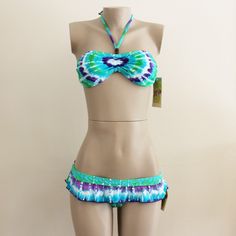 This Listing Is For A Swimsuit From Hobie. It Has A Halter Strap That Ties Behind The Neck With Wooden Beads On The Straps. Drawstring In The Center Of The Bust. When Drawstring Is Not Pulled, The Dye Design Looks Like A Heart. Also Ties Behind The Back, Removable Padding At Bust. Bottoms Have Ruffle Detail Around Waist. Fully Lined. 82% Nylon And 18% Spandex. Lined In 100% Polyester. Blue Adjustable Tankini For Summer, Adjustable Blue Tankini For Summer, Beachy Strapless Fitted Swimwear, Fitted Strapless Beachy Swimwear, Beachy Fitted Tankini For Festivals, Halter Strap, Swim Suit Bottoms, Wooden Beads, A Heart