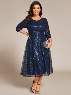 a woman wearing a blue dress with sequins