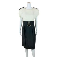 A vintage 1980s dress with a top and skirt illusion but it's really a dress! Has a cream top with epaulette's on the shoulders, built in shoulder pads, with a contrasting faux belt in a greige/brown/gray color with gold chains and buttons and a fitted skirt with a kick pleat in the back. Dress buttons in the back down to the waist and with a zipper from the waist down. LABEL: Split Decision, Made in USA FABRIC: - MARKED VINTAGE SIZE: - SHOULDERS: 20" SHOULDER TO WAIST: 14" BUST: 35" WAIST: 27" a Split Decision, Gold Chain Belt, Dress Buttons, Cream Top, 1980s Dresses, Cream Tops, Kick Pleat, Chain Belt, Button Dress